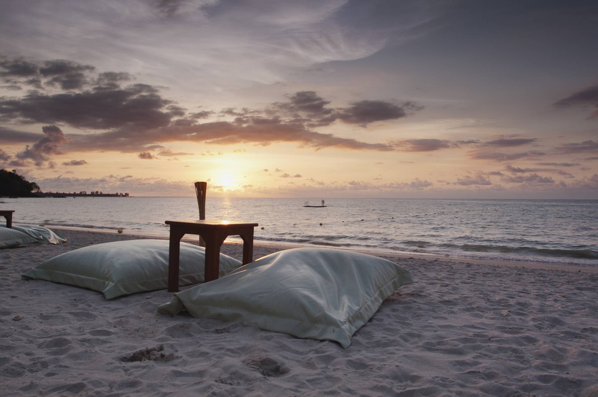 romantic dinner table on beach at sunset